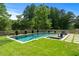 A refreshing pool with a spa and shallow entry, surrounded by lush grass and a wooden fence at 2373 Sagamore Hills Dr, Decatur, GA 30033