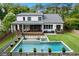 Beautiful backyard pool with a sun shelf, spa, large deck, covered patio, and landscaped yard at 2373 Sagamore Hills Dr, Decatur, GA 30033
