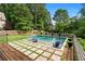 Backyard pool with a sun shelf, in-pool seating, patio and beautifully manicured lawn at 2373 Sagamore Hills Dr, Decatur, GA 30033
