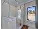 Modern shower features glass door, white subway tile, and a window bringing in natural light at 2373 Sagamore Hills Dr, Decatur, GA 30033