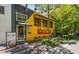 Quaint Bell Street Burritos building with yellow accents, sidewalk signage, and greenery on a sunny day at 260 Estoria St, Atlanta, GA 30316