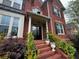 Charming front entry with brick steps, decorative columns, and lush plants enhancing curb appeal at 2688 Hidden Falls Ne Dr, Buford, GA 30519