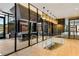 Modern amenity space with a chef's kitchen, bar seating, and access to an outdoor area at 40 12Th Ne St # 803, Atlanta, GA 30309
