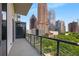 Spacious balcony with a glass railing and stunning city views of the skyline at 40 12Th Ne St # 803, Atlanta, GA 30309