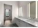 Elegant bathroom featuring double sinks, modern lighting, and a doorway view to the bedroom at 40 12Th Ne St # 803, Atlanta, GA 30309