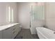 Sleek bathroom with a soaking tub, glass-enclosed shower, and modern vanity at 40 12Th Ne St # 803, Atlanta, GA 30309