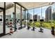 Modern gym with state-of-the-art equipment and floor-to-ceiling windows showcasing city views at 40 12Th Ne St # 803, Atlanta, GA 30309