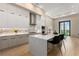 Bright kitchen with stainless steel appliances, a marble backsplash, and an island with seating at 40 12Th Ne St # 803, Atlanta, GA 30309