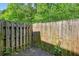 Enclosed backyard featuring a tall wooden fence, providing privacy and a secure outdoor space at 5019 Lower Elm St, Atlanta, GA 30349