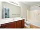 Bright bathroom with a bathtub-shower combo and a wood cabinet vanity with a white countertop at 5019 Lower Elm St, Atlanta, GA 30349