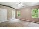 Bedroom featuring ample natural light, carpeted floors, and a ceiling fan at 5019 Lower Elm St, Atlanta, GA 30349