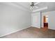 Spacious bedroom with a ceiling fan, neutral carpet, and an en suite bathroom at 5019 Lower Elm St, Atlanta, GA 30349