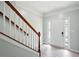 Bright entryway featuring a staircase, white door, and wood-look floors, offering a welcoming entrance at 5019 Lower Elm St, Atlanta, GA 30349