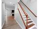 Open entryway with hardwood floors, staircase, and view into the living area with fireplace at 5019 Lower Elm St, Atlanta, GA 30349