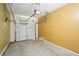 A single-car garage with a yellow wall and a closed white garage door at 5019 Lower Elm St, Atlanta, GA 30349