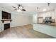 Open-concept living area with a fireplace and adjacent kitchen with breakfast bar seating at 5019 Lower Elm St, Atlanta, GA 30349