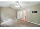 Spacious carpeted main bedroom with white ceiling fan and an open closet door for easy access at 5019 Lower Elm St, Atlanta, GA 30349
