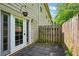 A quaint outdoor patio with stone tiles is adjacent to a charming home with a private wood fence at 5019 Lower Elm St, Atlanta, GA 30349