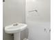 A small powder room with pedestal sink and chrome fixtures; a simple design at 5019 Lower Elm St, Atlanta, GA 30349