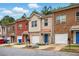 Exterior of a row of townhomes featuring brick facades, garages, and well-maintained landscaping at 5019 Lower Elm St, Atlanta, GA 30349