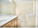 Bright bathroom features a double sink vanity, tiled floors, and combined shower and bathtub at 75 Saltcreek Pt, Sugar Hill, GA 30518