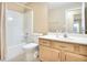 Bright bathroom with a shower-tub combo, a toilet, and vanity with storage at 75 Saltcreek Pt, Sugar Hill, GA 30518