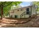 Backyard of a painted brick home with a covered patio and stairs leading to an upper entrance at 2889 Macon Sw Dr, Atlanta, GA 30354