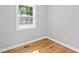 The bedroom features neutral paint, hardwood floors, and a window that lets in plenty of natural light at 2889 Macon Sw Dr, Atlanta, GA 30354