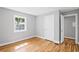 This bedroom features hardwood floors, neutral paint, and a window that allows in plenty of natural light at 2889 Macon Sw Dr, Atlanta, GA 30354