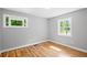 Light-filled bedroom with gleaming hardwood floors, neutral walls, and green outdoor views at 2889 Macon Sw Dr, Atlanta, GA 30354