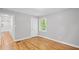 Bedroom showcasing hardwood floors, freshly painted walls, and natural light from the window at 2889 Macon Sw Dr, Atlanta, GA 30354