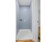 Bright and clean laundry room with white hexagon tile floor, white trim, and pale blue walls at 2889 Macon Sw Dr, Atlanta, GA 30354
