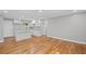 Open-concept living space with hardwood floors seamlessly transitions into a modern kitchen at 2889 Macon Sw Dr, Atlanta, GA 30354