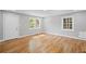 Bright, inviting living room featuring a white door, hardwood floors, and natural light at 2889 Macon Sw Dr, Atlanta, GA 30354