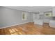 Spacious living room featuring new hardwood floors, white trim, and plenty of natural light at 2889 Macon Sw Dr, Atlanta, GA 30354