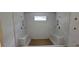 A bright shower room features a bench, tile walls, and a small window at 2918 Level Ridge Rd, Atlanta, GA 30354