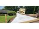 Two-story home features a long concrete driveway and attached garage at 2918 Level Ridge Rd, Atlanta, GA 30354