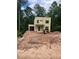 Beautiful two-story home with a garage and modern design set against a backdrop of lush greenery at 2918 Level Ridge Rd, Atlanta, GA 30354