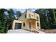 Modern two-story house with an attached garage and an unfinished yard at 2918 Level Ridge Rd, Atlanta, GA 30354