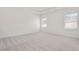 Spacious bedroom featuring neutral carpet, tray ceilings and natural light from two large windows at 3269 Shirecrest Ln, Dacula, GA 30019
