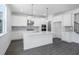 Bright kitchen features white cabinets, a large island, stainless steel appliances, and stylish pendant lighting at 3269 Shirecrest Ln, Dacula, GA 30019