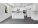 Bright kitchen features white cabinets, a large island, stainless steel appliances, and stylish pendant lighting at 3269 Shirecrest Ln, Dacula, GA 30019