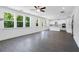 Spacious living room open to a kitchen with laminate flooring and large windows at 3269 Shirecrest Ln, Dacula, GA 30019