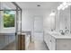 Luxurious bathroom featuring a glass-enclosed shower, soaking tub, and double vanity with modern fixtures at 3269 Shirecrest Ln, Dacula, GA 30019