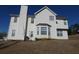 Two-story home with white siding, a bay window, well-maintained yard, and chimney at 6179 Swabia Ln, Stone Mountain, GA 30087