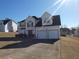 Charming two-story home with a well-maintained lawn and an attached two-car garage at 6179 Swabia Ln, Stone Mountain, GA 30087