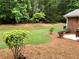 Landscaped backyard with mature trees and green lawn at 1818 Brandy Woods Se Dr, Conyers, GA 30013