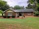 Well-maintained brick house with a lush green lawn and mature trees at 1818 Brandy Woods Se Dr, Conyers, GA 30013