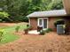 Brick home backyard with small patio and landscaping at 1818 Brandy Woods Se Dr, Conyers, GA 30013