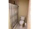 Bathroom features a shower with a curtain and tiled floor, as well as toilet at 1818 Brandy Woods Se Dr, Conyers, GA 30013